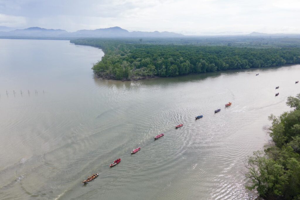 The sea going flotilla carrying Buddha images from the mainland to Ko Sukorn as part of the Marine Pulling Buddha Procession.